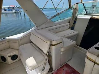 Slide: The Image of 1988 Wellcraft Gran Sport boat interior with white seating and waterfront view. - 8