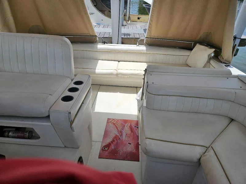Slide: The Image of Interior of 1988 Wellcraft Gran Sport boat with white seating and cup holders. - 9