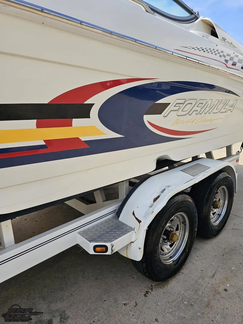 Slide: The Image of 2005 Formula 292 FASTech boat on trailer with colorful graphics. - 24