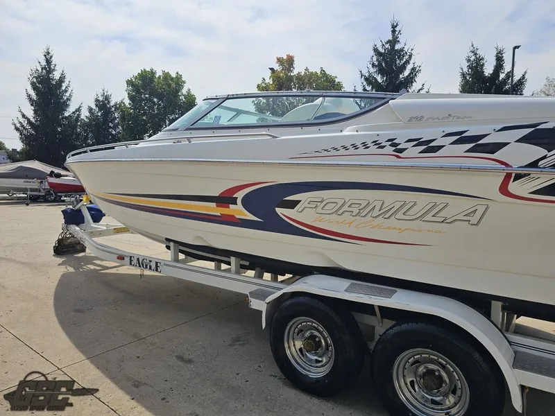 Slide: The Image of 2005 Formula 292 FASTech boat on trailer, vibrant graphics, parked outdoors. - 26