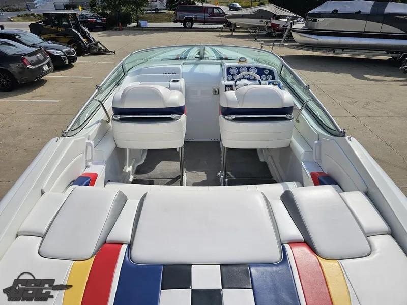 Slide: The Image of 2005 Formula 292 FASTech boat interior with colorful seating and dashboard in a parking lot. - 44