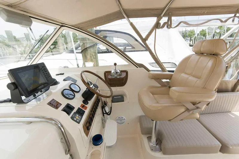 Slide: The Image of 2004 Mainship Pilot 30-II helm with leather captain's chair and navigation equipment. - 5