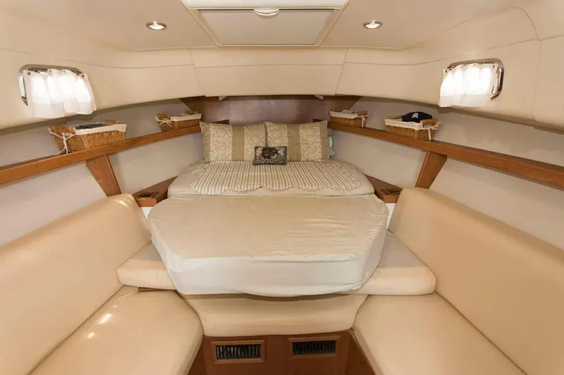 Slide: The Image of 2004 Mainship Pilot 30-II cabin interior with cozy bed and seating area. - 6