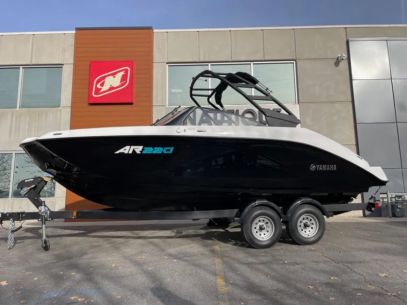 The Image of 2025 Yamaha Boats AR220 on trailer outside dealership. - 1