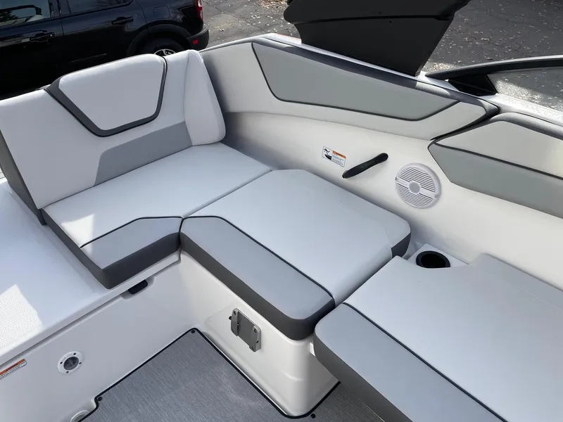 Slide: The Image of 2025 Yamaha Boats AR220 interior seating with gray and white upholstery. - 10