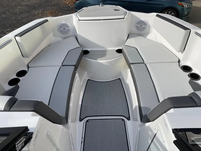 Slide: The Image of 2025 Yamaha Boats AR220 interior with gray seating and cup holders. - 12