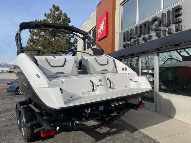 Slide: The Image of 2025 Yamaha Boats AR220 displayed outside Nautique dealership. - 4