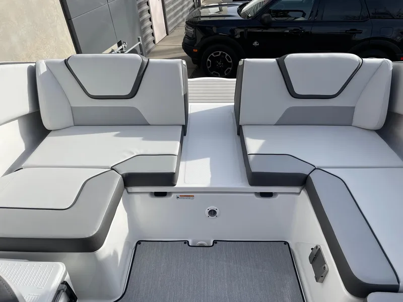 Slide: The Image of 2025 Yamaha Boats AR220 interior seating with modern design and gray upholstery. - 9