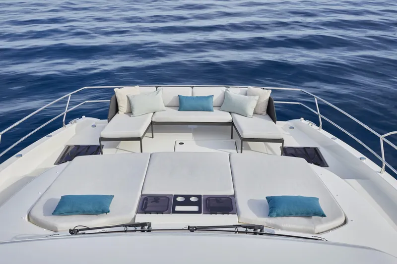 Slide: The Image of Luxurious 2025 Prestige M48 yacht deck with plush seating and ocean view. - 16