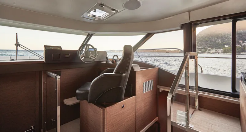Slide: The Image of Luxurious 2025 Prestige M48 yacht interior with modern helm and panoramic sea view. - 20