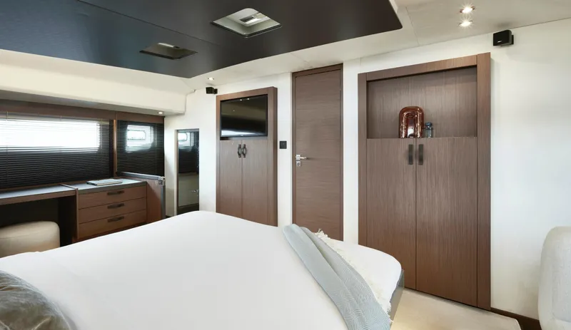 Slide: The Image of Luxurious interior of 2025 Prestige M48 yacht bedroom with modern furnishings and elegant design. - 24