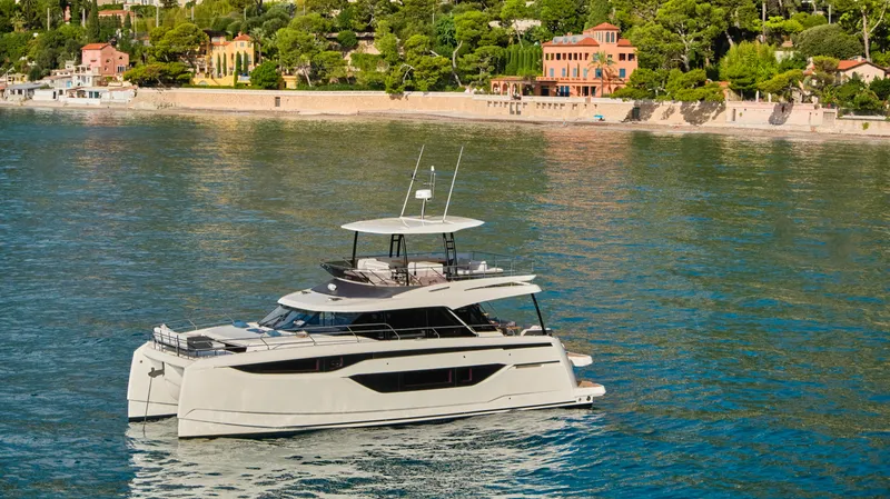 Slide: The Image of Prestige M48 yacht cruising near scenic coastline, 2025 model. - 4