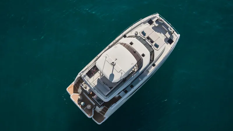 Slide: The Image of Aerial view of 2025 Prestige M48 yacht on clear blue water. - 7