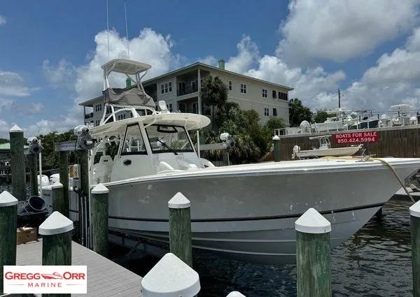 Slide: The Image of 2021 Regulator 41 boat docked at marina, clear sky, Gregg Orr Marine sign. - 10
