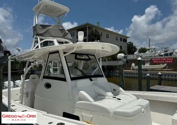 Slide: The Image of 2021 Regulator 41 boat docked, featuring a sleek design and spacious seating. - 13