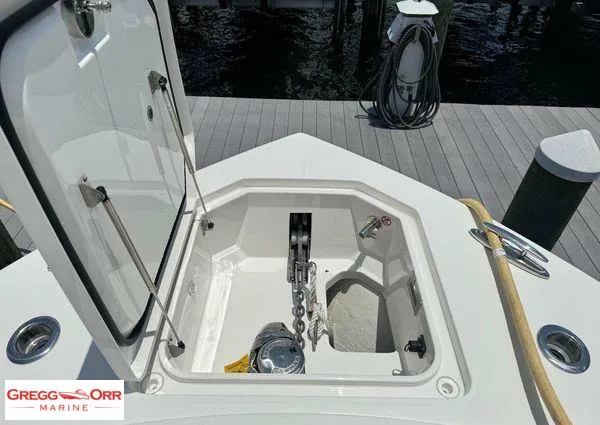 Slide: The Image of 2021 Regulator 41 anchor locker open at dock, showcasing chain and winch. - 16