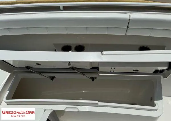 Slide: The Image of 2021 Regulator 41 boat storage compartment, open lid, white interior, Gregg Orr Marine logo. - 18