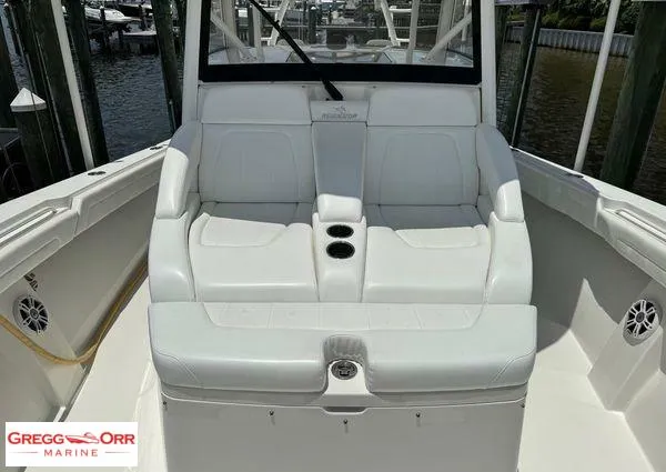 Slide: The Image of 2021 Regulator 41 boat interior with white seating and cup holders, docked at marina. - 22