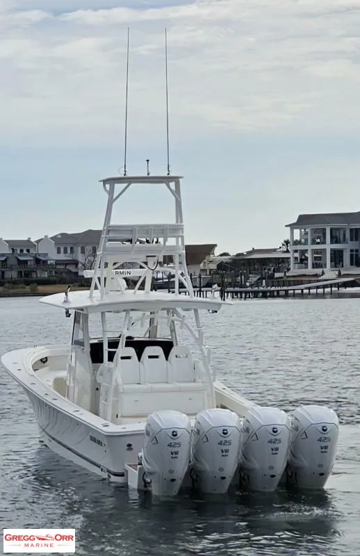 Slide: The Image of 2021 Regulator 41 boat with four Yamaha 425 engines, docked near waterfront homes. - 6