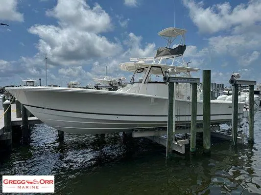 Slide: The Image of 2021 Regulator 41 boat on lift at marina, cloudy sky background. - 8
