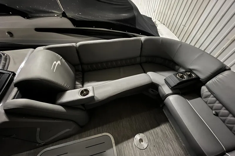 Slide: The Image of 2020 Bennington QX 25 QXFBWA Fastback interior with gray leather seating and cup holders. - 5