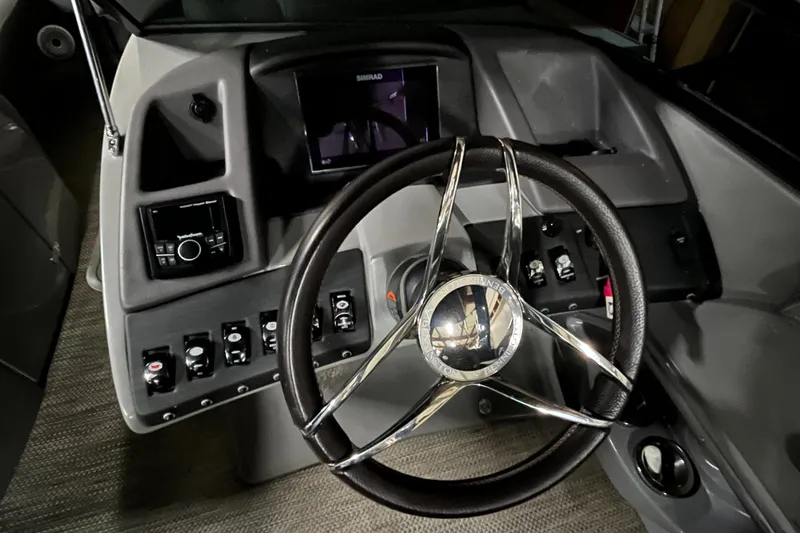 Slide: The Image of 2020 Bennington QX 25 QXFBWA Fastback boat dashboard with steering wheel and controls. - 9
