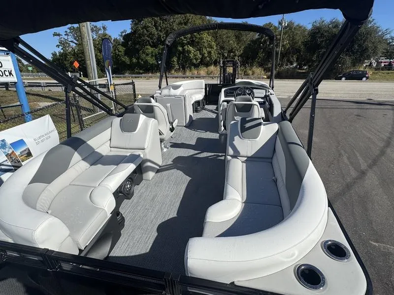 Slide: The Image of 2025 Avalon LSZ Quad Lounger pontoon boat with spacious seating and modern design. - 10