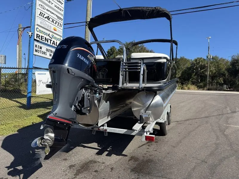 Slide: The Image of 2025 Avalon LSZ Quad Lounger pontoon boat with Yamaha engine on trailer. - 3