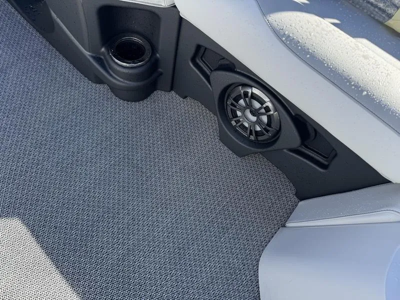 Slide: The Image of 2025 Avalon LSZ Quad Lounger interior with speaker and cup holder on textured flooring. - 9