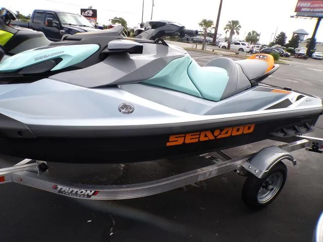 Slide: The Image of 2024 Sea-Doo Waverunner GTI on trailer, sleek design, parked outdoors. - 17