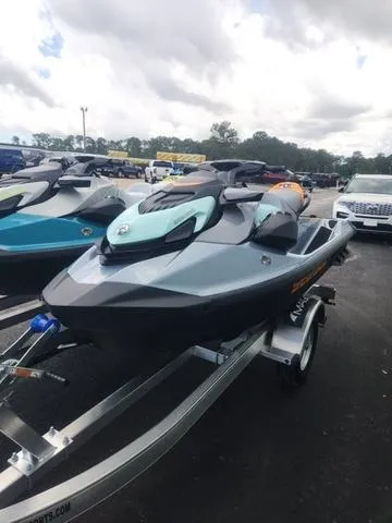 Slide: The Image of 2024 Sea-Doo Waverunner GTI on trailer, parked outdoors under cloudy sky. - 20