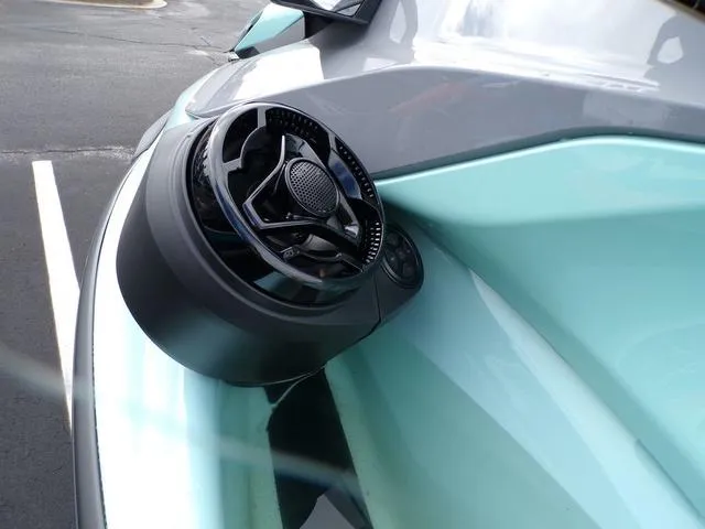 Slide: The Image of 2024 Sea-Doo Waverunner GTI speaker detail, sleek design, parked on asphalt. - 3