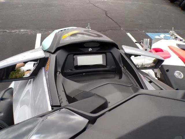 Slide: The Image of 2024 Sea-Doo Waverunner GTI dashboard and controls, parked in a lot. - 4