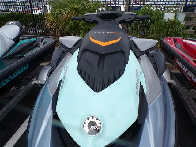 Slide: The Image of 2024 Sea-Doo Waverunner GTI in showroom, sleek design with vibrant colors. - 10