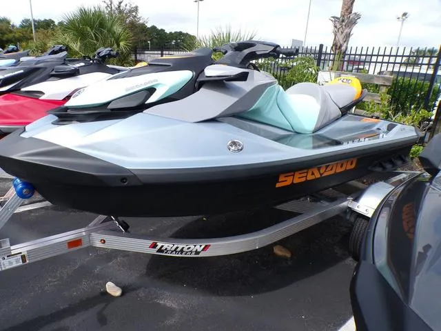 Slide: The Image of 2024 Sea-Doo Waverunner GTI on trailer, sleek design, parked outdoors. - 14