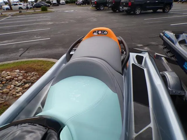 Slide: The Image of 2024 Sea-Doo Waverunner GTI in parking lot, showcasing sleek design and seating. - 9