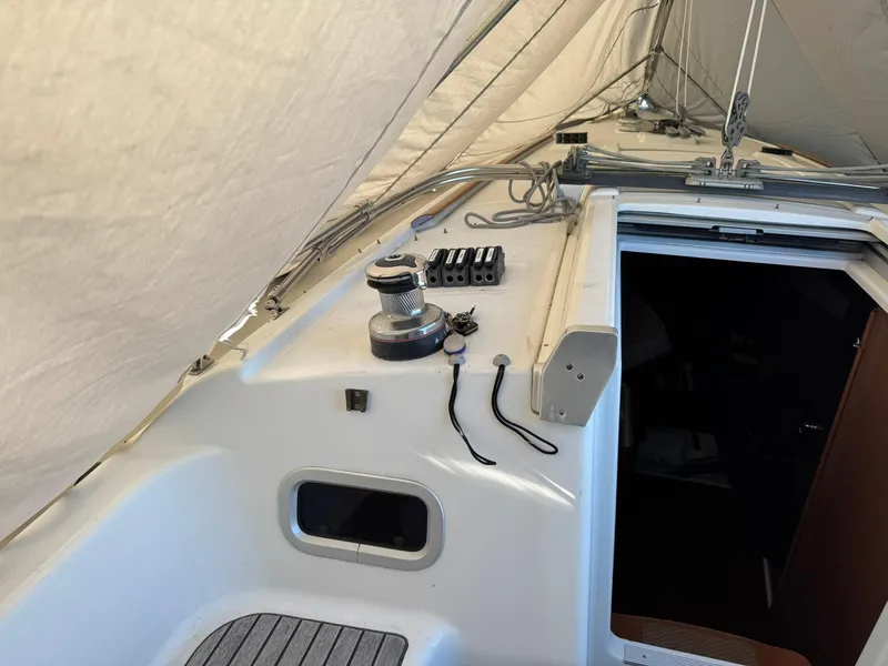 Slide: The Image of Beneteau Oceanis 34 sailboat deck, 2013 model, featuring winch and cabin entrance. - 12