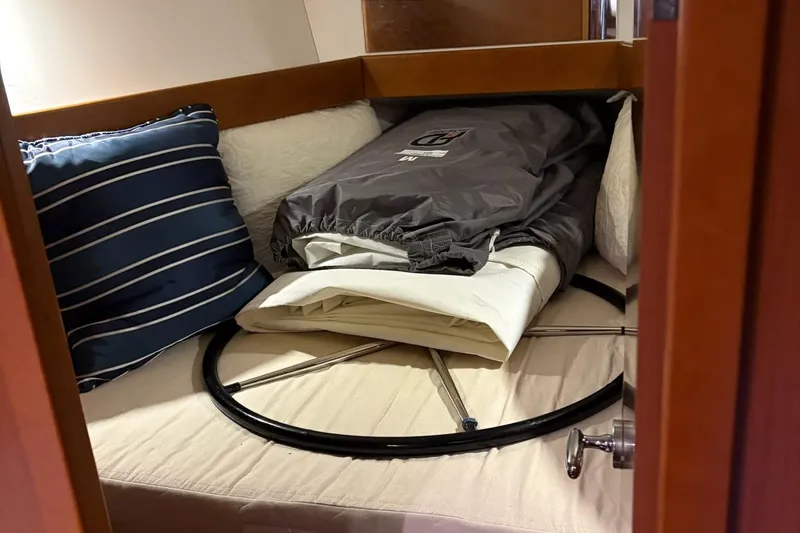 Slide: The Image of Cozy cabin interior of 2013 Beneteau Oceanis 34 with cushions and sailing gear. - 16