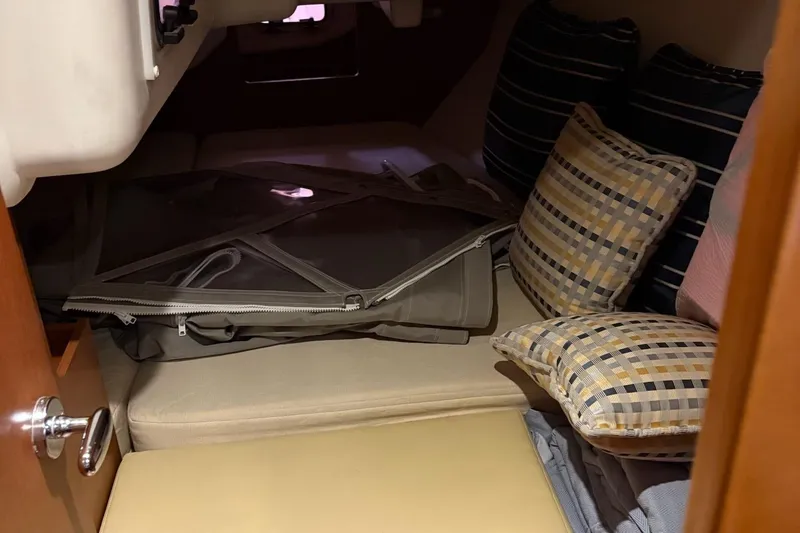 Slide: The Image of Cozy cabin interior of 2013 Beneteau Oceanis 34 with cushions and storage. - 17