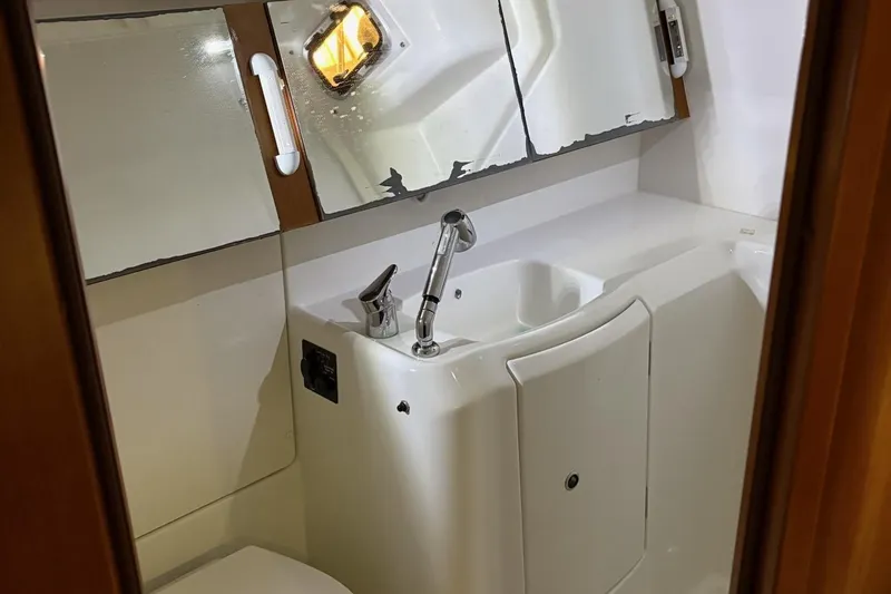 Slide: The Image of Beneteau Oceanis 34 bathroom interior, featuring sink and mirror, 2013 model. - 18