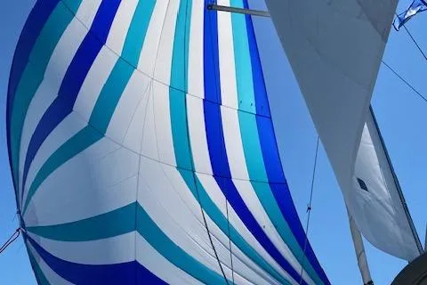 Slide: The Image of Colorful sails of a 2013 Beneteau Oceanis 34 against a clear blue sky. - 2