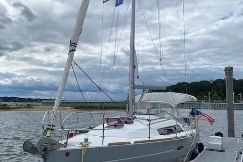 Slide: The Image of 2013 Beneteau Oceanis 34 sailboat docked on a cloudy day. - 3