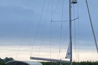 Slide: The Image of Beneteau Oceanis 34 sailboat, 2013 model, docked under a cloudy sky. - 4