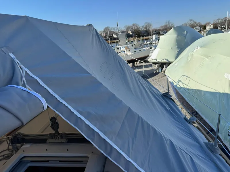 Slide: The Image of Beneteau Oceanis 34 sailboat, 2013 model, covered and docked in a marina. - 6