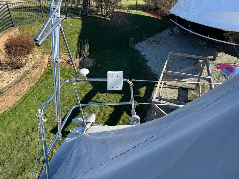 Slide: The Image of Beneteau Oceanis 34 sailboat, 2013 model, covered and docked in a grassy yard. - 7