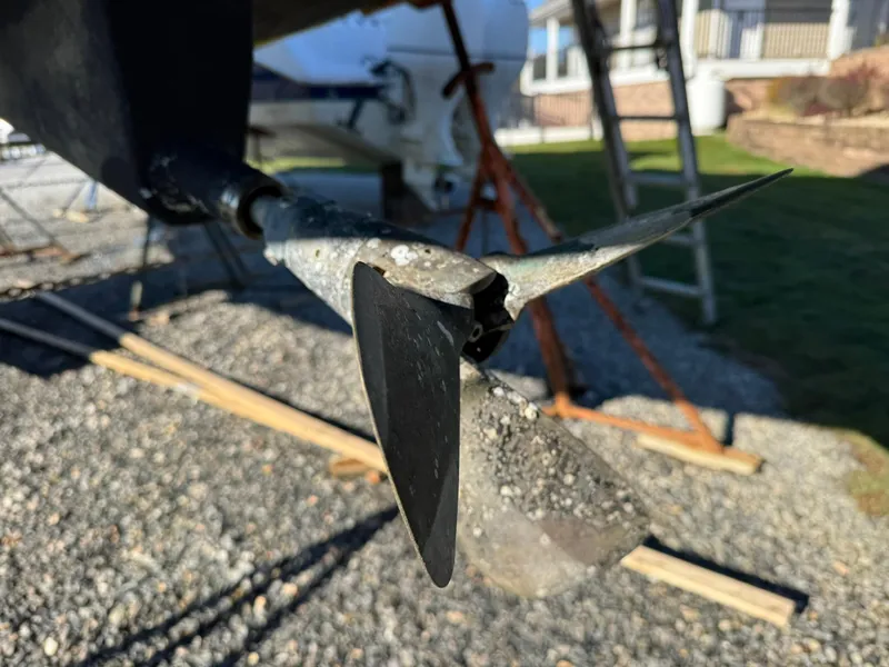 Slide: The Image of Close-up of a 2013 Beneteau Oceanis 34 sailboat propeller on gravel surface. - 8