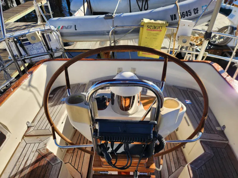 Slide: The Image of Cockpit of a 2000 Regina 43 sailboat with wooden deck and steering wheel. - 10