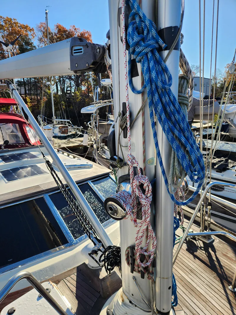 Slide: The Image of Sailboat deck with ropes and mast, Regina 43 model, year 2000, in a marina setting. - 12