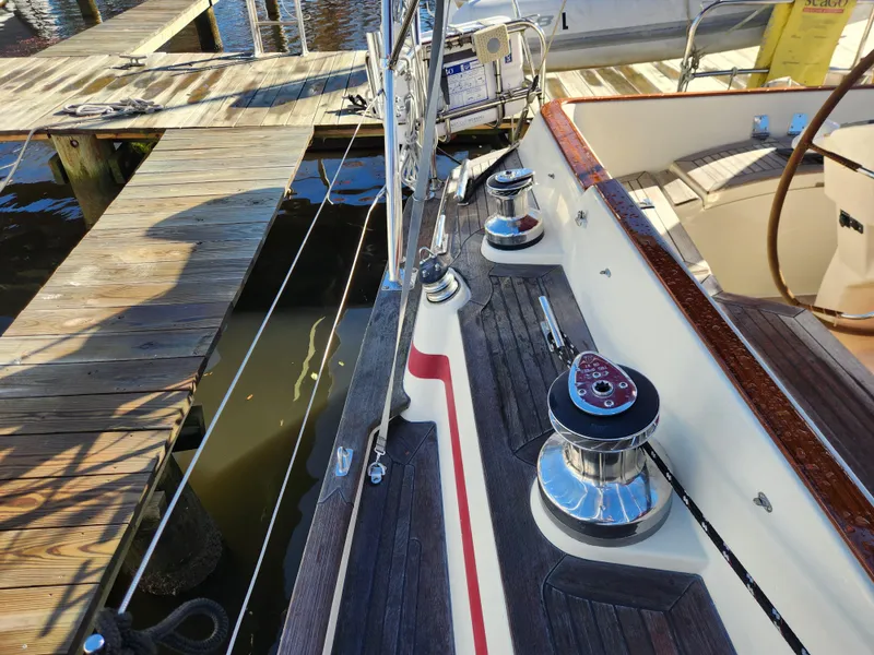 Slide: The Image of Sailboat deck with winches, Regina 43 model, docked at a wooden pier. - 16