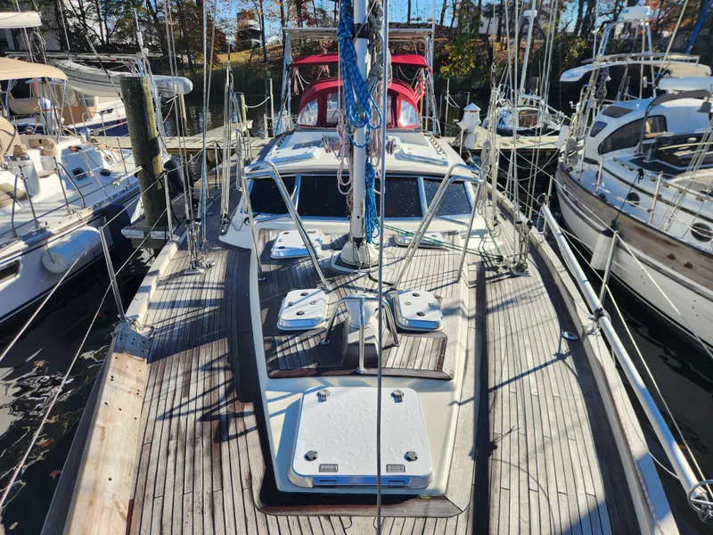 Slide: The Image of Sailboat docked at marina, Regina 43 model, year 2000, with wooden deck and rigging. - 17